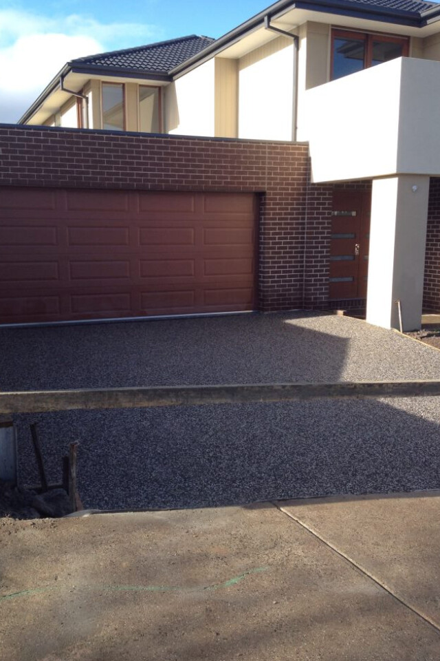 Exposed aggregate driveway with garage